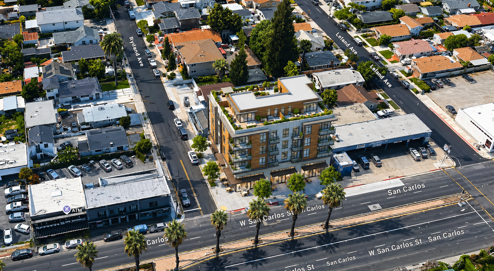 Aerial view of a five-story mixed-use building with ground-floor commercial on the corner